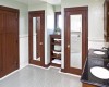 Rounding out this oversized vintage bathroom was the furniture piece used for the double granite sink. Included are the double personal closets and mirrored doors with a butler pantry service area between.